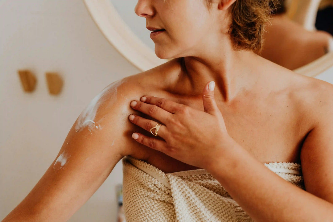 a_woman_applies_body_lotion_for_skincare_highlighting_self