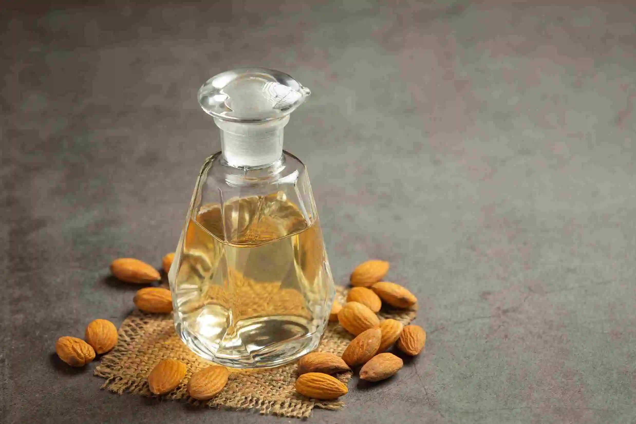 almond_oil_bottle_dark_background