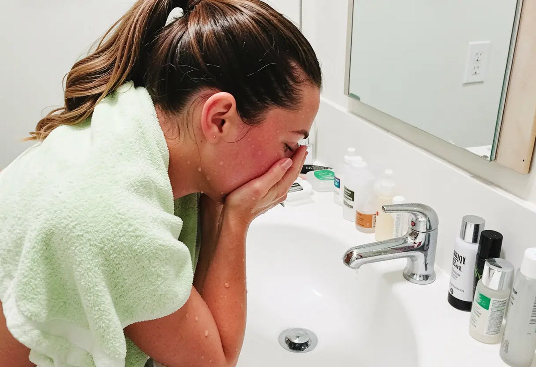Woman following a body care routine for dry skin, showering and moisturising steps