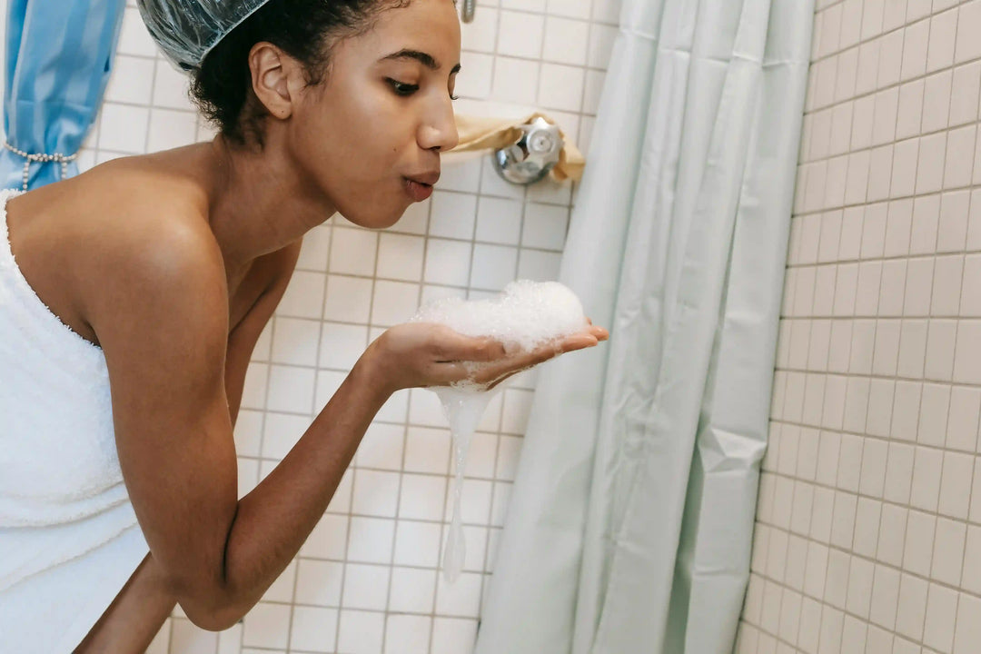 woman_in_shower_blowing_foam_and_enjoying_refreshing_morning_bath_routine